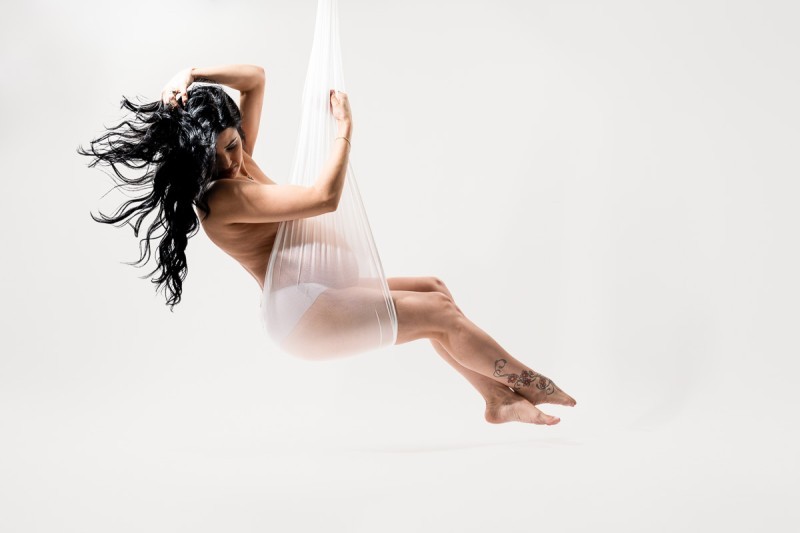 Iconic maternity portrait suspended in white fabric