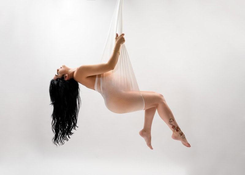 Tampa maternity portrait suspended in white fabric – graceful fine art