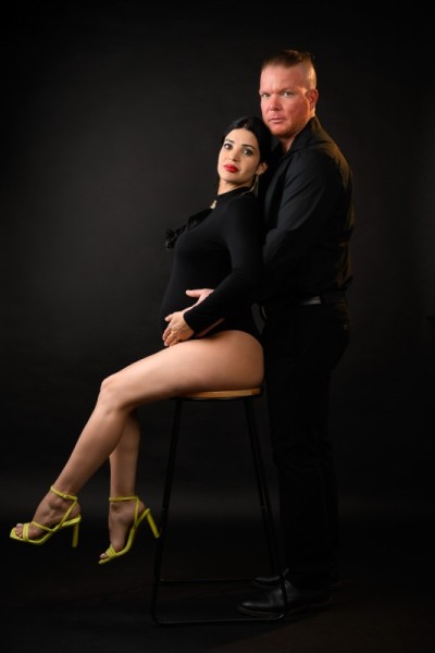 Bold and elegant maternity couple portrait in black