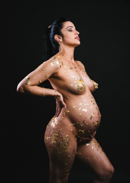Fine art maternity photo with gold leaf and confident pose