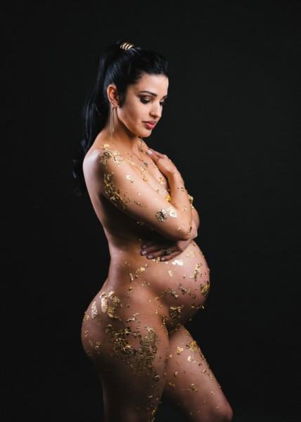 Artistic maternity photo with gold leaf and graceful profile pose