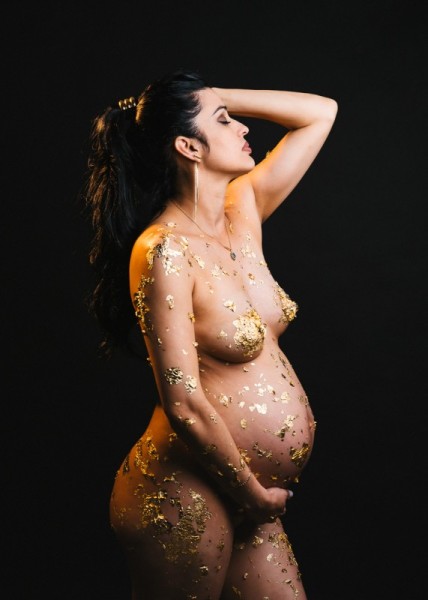 Powerful artistic maternity portrait with gold leaf and graceful pose