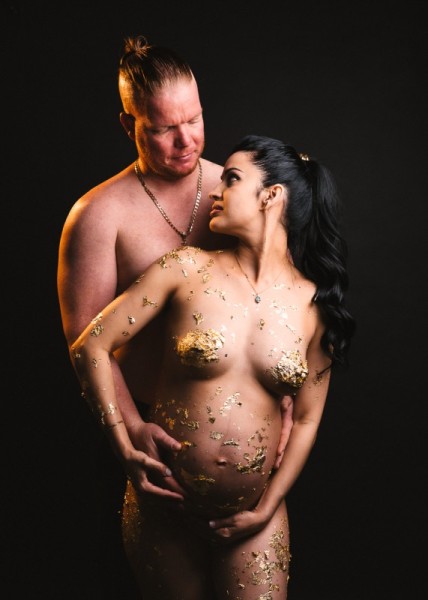 Artistic maternity couple photo with gold leaf and emotional connection